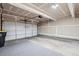 The spacious garage features a large white door, ample lighting, and concrete floors at 821 Stony Mesa Pl, Castle Rock, CO 80108