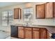Bright kitchen featuring wood cabinets, laminate countertops, and a stainless steel dishwasher at 821 Stony Mesa Pl, Castle Rock, CO 80108