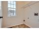 The compact laundry room offers a window view and tile flooring at 821 Stony Mesa Pl, Castle Rock, CO 80108