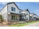 Attractive row of modern homes featuring white siding and gray trim on a sunny day at 3580 W 62Nd Pl, Denver, CO 80221