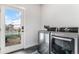 Laundry room with front-load washer and dryer and access to the outdoors at 3580 W 62Nd Pl, Denver, CO 80221