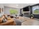 Open living room with large windows, modern fireplace, and contemporary decor at 3580 W 62Nd Pl, Denver, CO 80221
