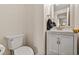 Contemporary powder room with white vanity, marble top and gold fixtures at 1599 W Beekman Pl, Denver, CO 80221