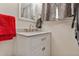 Bathroom featuring a white cabinet sink with brushed nickel hardware and a matching framed mirror at 1599 W Beekman Pl, Denver, CO 80221