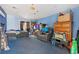 Bedroom with blue walls and carpet featuring a recliner and minimal decor at 1599 W Beekman Pl, Denver, CO 80221