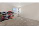 Bright bedroom features a large window and neutral carpeting at 1599 W Beekman Pl, Denver, CO 80221