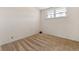 Bedroom featuring plush carpet, neutral paint, and natural light through the double paned windows at 1599 W Beekman Pl, Denver, CO 80221