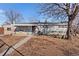 Charming single-story home with large tree and winter landscaping at 1599 W Beekman Pl, Denver, CO 80221