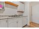 Kitchen area featuring white cabinets, granite countertops, stainless sink, and tile floor at 1599 W Beekman Pl, Denver, CO 80221