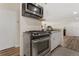 A kitchen featuring a stainless steel oven and bright white cabinetry at 1599 W Beekman Pl, Denver, CO 80221
