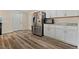 Kitchen featuring stainless steel refrigerator and range with bright white cabinets at 1599 W Beekman Pl, Denver, CO 80221