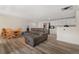 Open living space featuring dining area, gray sofa and bright white kitchen at 1599 W Beekman Pl, Denver, CO 80221