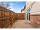 Fenced backyard and sliding glass door leading to the interior of the home at 4555 S Lowell Blvd, Denver, CO 80236