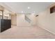 Spacious carpeted basement featuring recessed lighting and a staircase to upper level at 4555 S Lowell Blvd, Denver, CO 80236