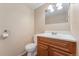 Cozy bathroom featuring a wood vanity, white sink, and neutral paint at 4555 S Lowell Blvd, Denver, CO 80236
