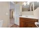 Bathroom featuring wood vanity, single sink, mirror, and neutral paint at 4555 S Lowell Blvd, Denver, CO 80236
