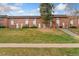 A row of well-kept townhomes on a lush green lawn showcasing a desirable community at 4555 S Lowell Blvd, Denver, CO 80236