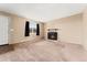 Living room features a cozy fireplace, carpet, and natural light at 4555 S Lowell Blvd, Denver, CO 80236