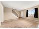Inviting living room with carpet, staircase, neutral tones, and ample natural light at 4555 S Lowell Blvd, Denver, CO 80236