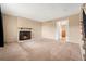 Cozy living room featuring a classic fireplace, carpet, and neutral paint at 4555 S Lowell Blvd, Denver, CO 80236
