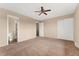 Spacious main bedroom featuring neutral paint, carpet, and multiple doorways at 4555 S Lowell Blvd, Denver, CO 80236