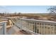 A serene view of the backyard with natural landscaping seen from the home's wooden deck at 1957 S Coolidge Way, Aurora, CO 80018