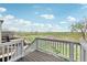 Scenic view from the deck overlooking a green field and the horizon, framed by a white fence at 1957 S Coolidge Way, Aurora, CO 80018