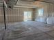 Walkout basement with concrete floors, sheetrock walls, and sliding glass doors to the yard at 1957 S Coolidge Way, Aurora, CO 80018