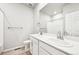 Bright bathroom featuring double sinks, white cabinets, and a large mirror reflecting the shower at 1957 S Coolidge Way, Aurora, CO 80018
