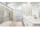 Modern bathroom featuring a double vanity and tiled walk-in shower at 1957 S Coolidge Way, Aurora, CO 80018