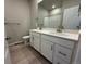Bathroom featuring a double vanity, white cabinets, and a shower/tub combo at 1957 S Coolidge Way, Aurora, CO 80018