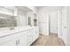 Bright bathroom with double sink vanity and luxury vinyl plank flooring at 1957 S Coolidge Way, Aurora, CO 80018
