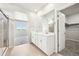 Bathroom featuring double vanity sinks, mirror, and glass shower stall at 1957 S Coolidge Way, Aurora, CO 80018