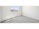 Bedroom featuring neutral carpet, a window, and two electrical outlets at 1957 S Coolidge Way, Aurora, CO 80018