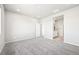 Carpeted bedroom showcasing ensuite bathroom with walk-in closet at 1957 S Coolidge Way, Aurora, CO 80018