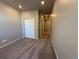 Bedroom with neutral walls, carpet, closet with sliding doors and door to another room at 1957 S Coolidge Way, Aurora, CO 80018