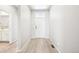 Bright entryway featuring light wood floors and white walls, leading to a modern interior at 1957 S Coolidge Way, Aurora, CO 80018