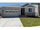 Charming single-Gathering home featuring stone accents, a two-car garage, and a well-manicured lawn at 1957 S Coolidge Way, Aurora, CO 80018