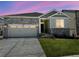 Charming single-Gathering home featuring stone accents, a two-car garage, and a well-manicured lawn at 1957 S Coolidge Way, Aurora, CO 80018