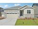 Close up of a lovely single-Gathering home featuring stone accents and a two-car garage at 1957 S Coolidge Way, Aurora, CO 80018