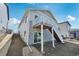Rear exterior showcasing the deck, stone accents, and backyard at 1957 S Coolidge Way, Aurora, CO 80018