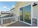 Deck area showing the adjacent field, exterior stone work, and a sliding glass door at 1957 S Coolidge Way, Aurora, CO 80018