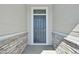 Modern front door with gray finish, accented by stone siding and clean architectural lines at 1957 S Coolidge Way, Aurora, CO 80018