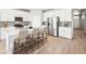 Charming kitchen features white cabinets, stainless appliances, and an island with barstool seating at 1957 S Coolidge Way, Aurora, CO 80018