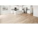 Bright, open-concept kitchen features a large island, stainless steel appliances, and hardwood flooring at 1957 S Coolidge Way, Aurora, CO 80018