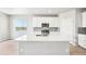 Modern kitchen with stainless steel appliances, large center island, and hardwood floors at 1957 S Coolidge Way, Aurora, CO 80018
