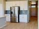 Spacious kitchen includes stainless steel refrigerator and ample cabinet space at 1957 S Coolidge Way, Aurora, CO 80018
