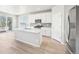 Modern kitchen with stainless steel appliances and center island and hardwood floors at 1957 S Coolidge Way, Aurora, CO 80018