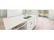 Kitchen island featuring stainless steel sink and appliances plus a view from the sliding doors at 1957 S Coolidge Way, Aurora, CO 80018