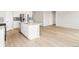 Modern kitchen boasts stainless steel appliances, a center island with sink, and stylish backsplash at 1957 S Coolidge Way, Aurora, CO 80018